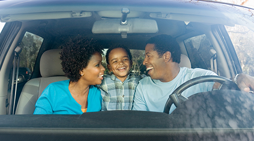 Smiling African Family of three inside the vehicle - Free Insurance Quotes
